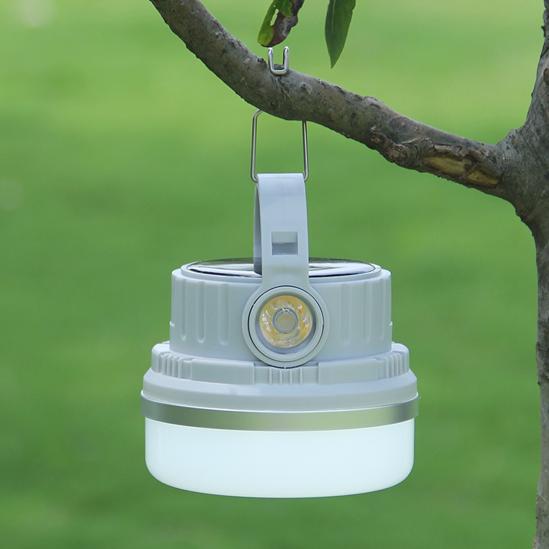Three camping lantern models compared on a wooden rail