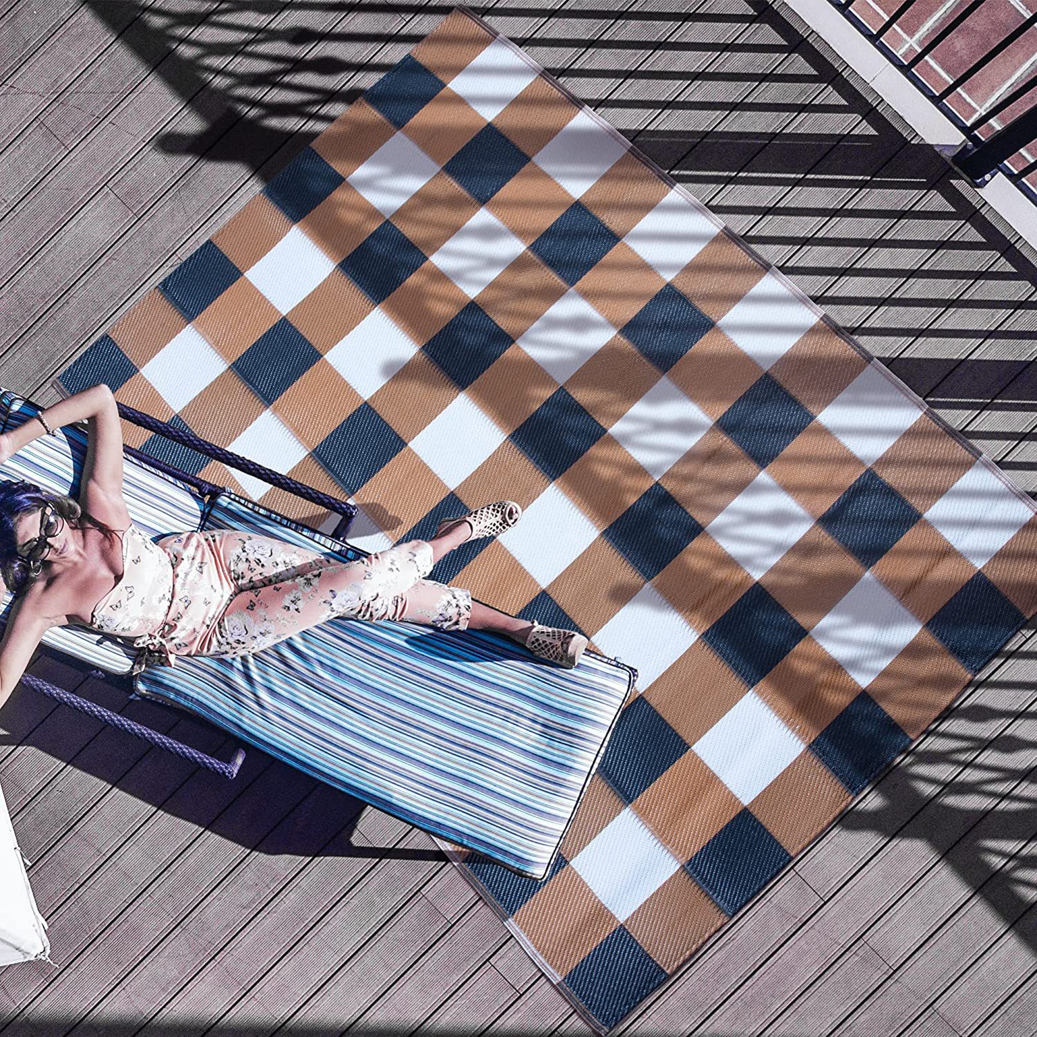 Outdoor ground mat on a balcony patio deck with lounge chair